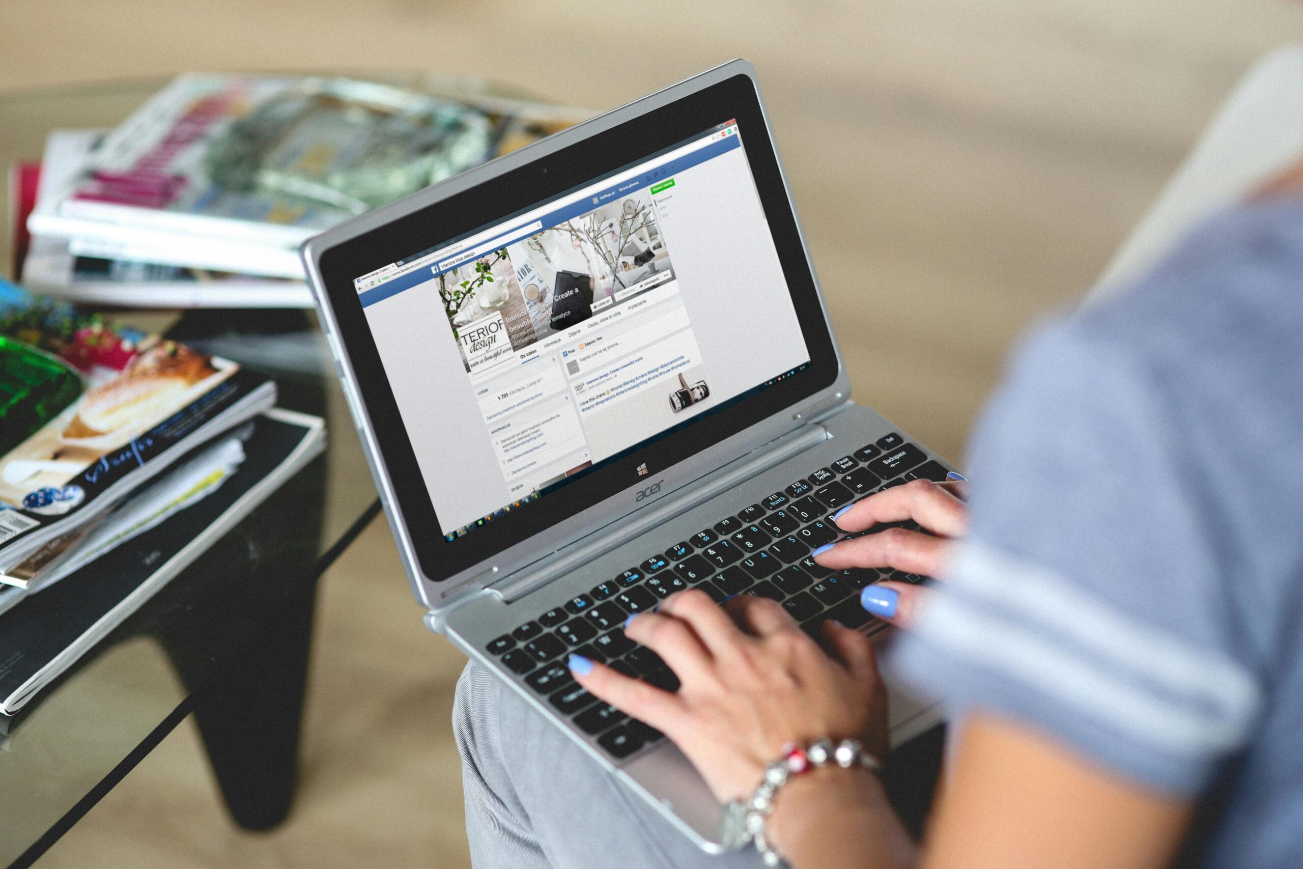A person managing a Facebook business page on a laptop, highlighting social media management in the best digital marketing services.